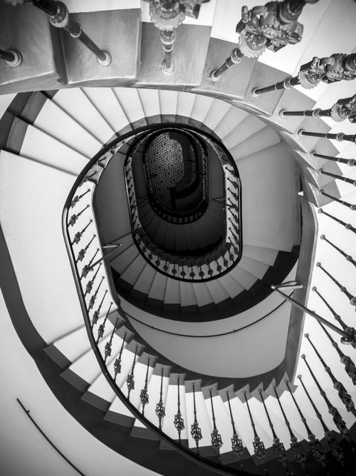 Free Black and white photo of a spiral staircase in Wrocław, Poland, showcasing elegant architectural design. Stock Photo