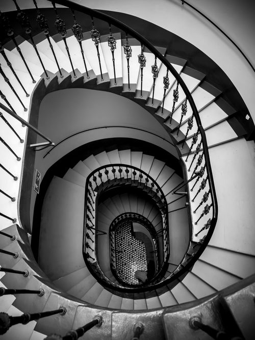 Free Black and white photo of a spiral staircase in Wrocław, Poland showcasing architectural elegance. Stock Photo