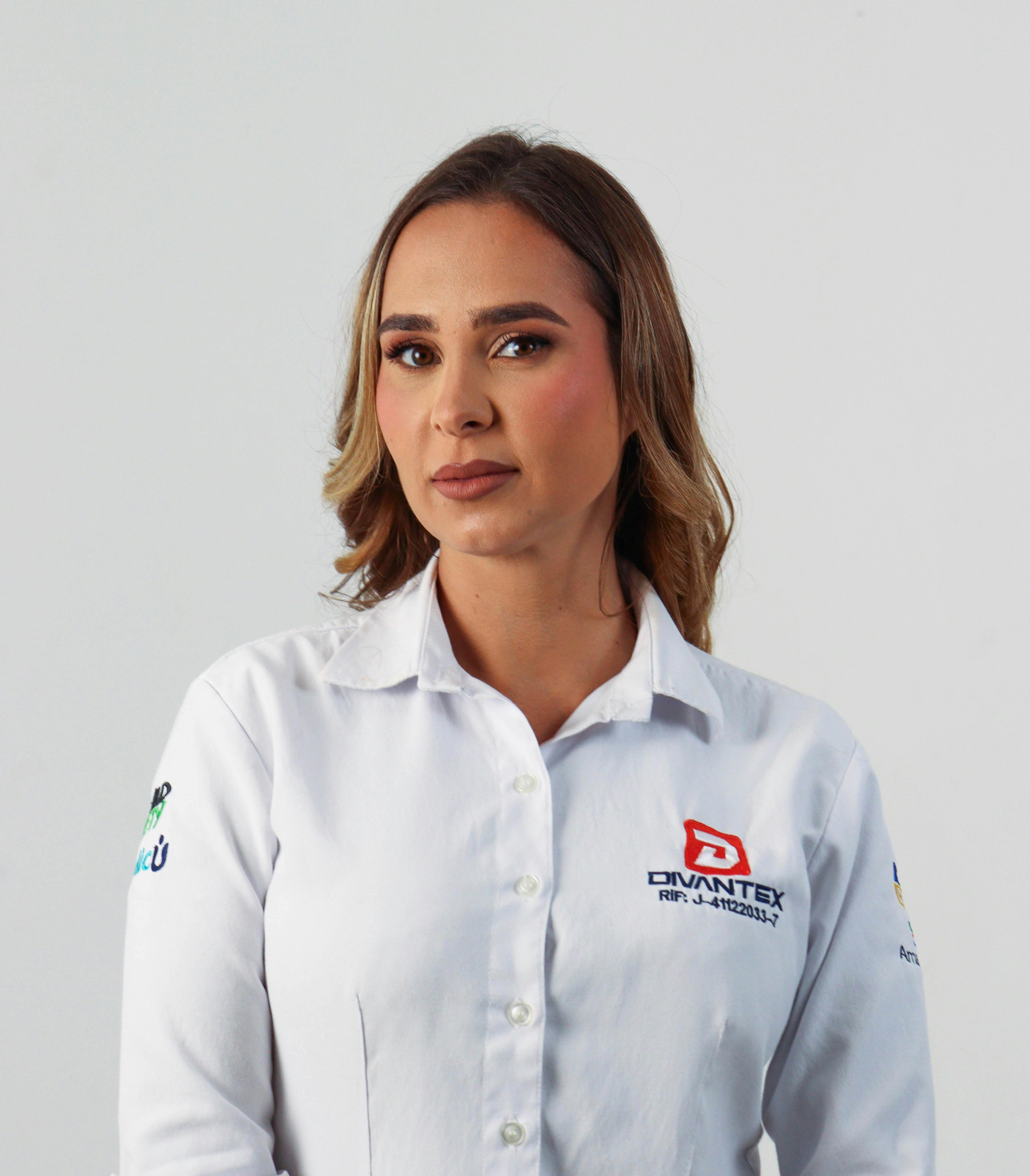 Portrait of a woman in corporate attire showcasing professionalism with a plain background.
