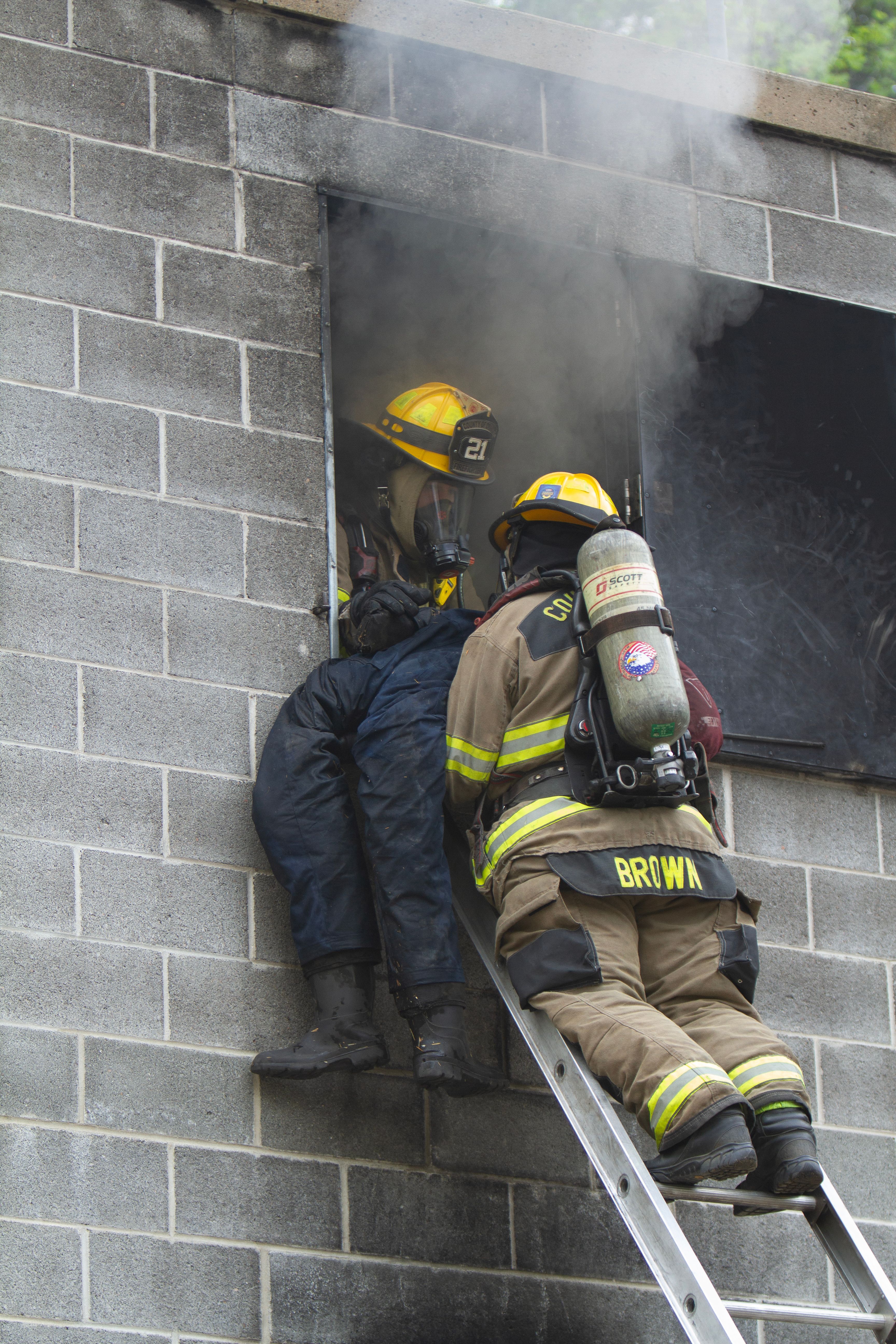 Firefighters Rescuing Person from Burning Building · Free Stock Photo