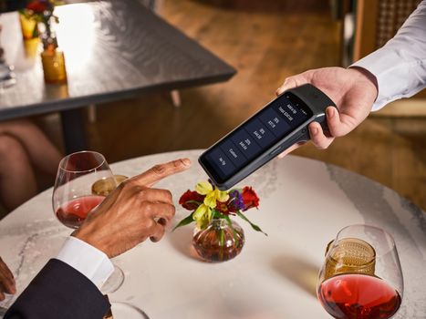 Elegant fine dining setting with a digital point of sale system for seamless payment and tipping.
