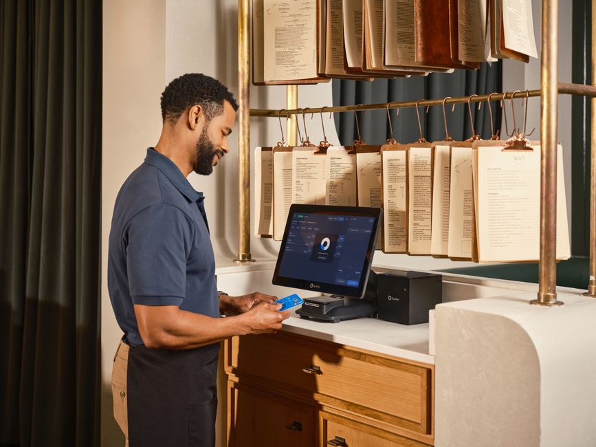 Server using a point of sale system to process a credit card payment in a restaurant setting. Server using a point of sale system to process a credit card payment in a restaurant setting.