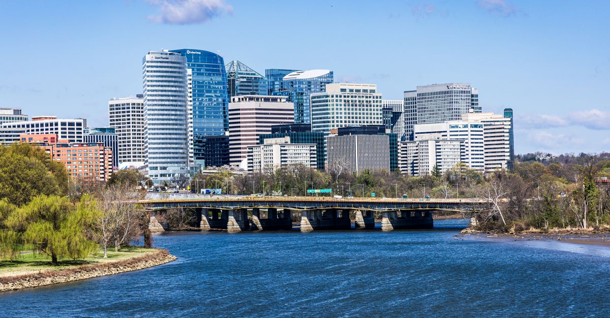 Stunning view of Rosslyn's skyline with the Arlington Memorial Bridge spanning the Potomac River.