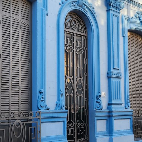 Free Vibrant blue Art Nouveau architecture with intricate details and ornate ironwork. Stock Photo