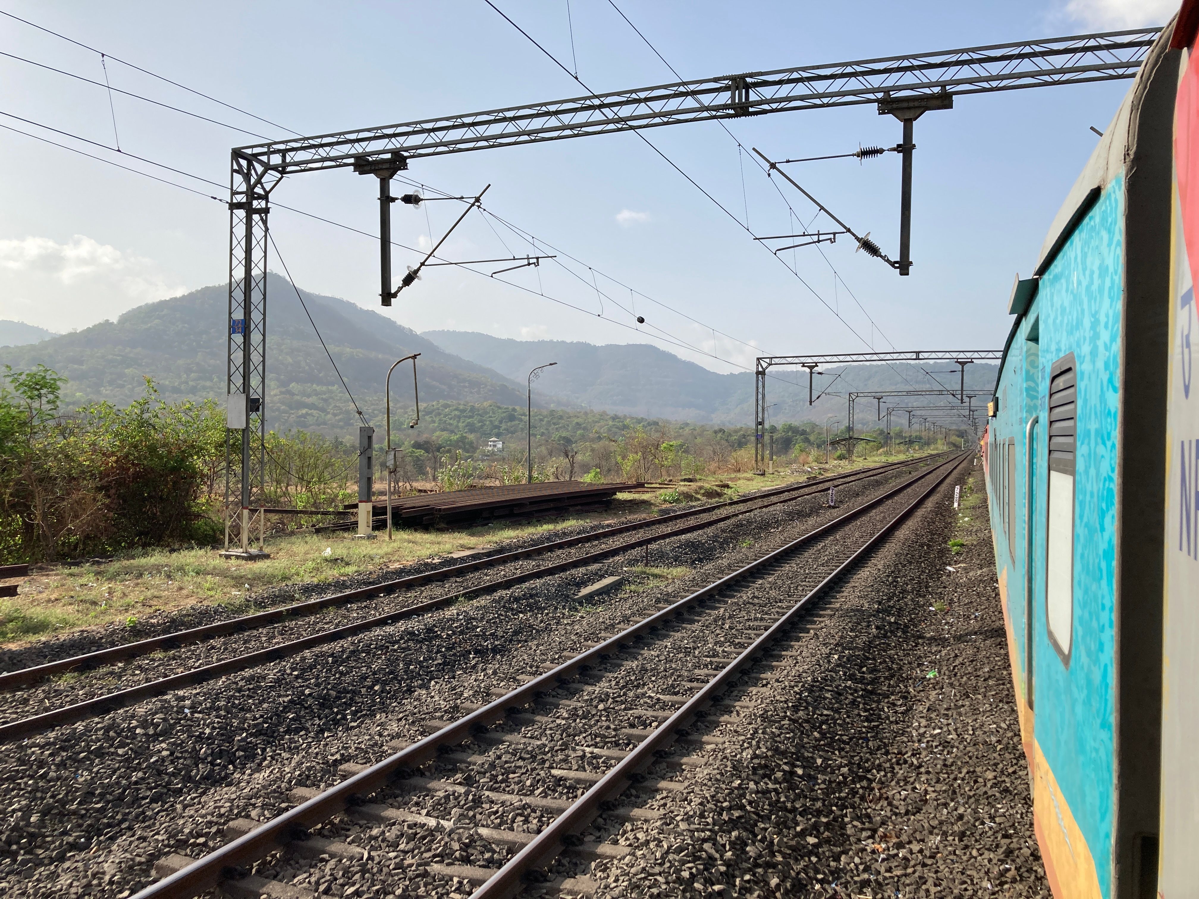 Experience a scenic train ride through lush mountains and expansive landscapes.