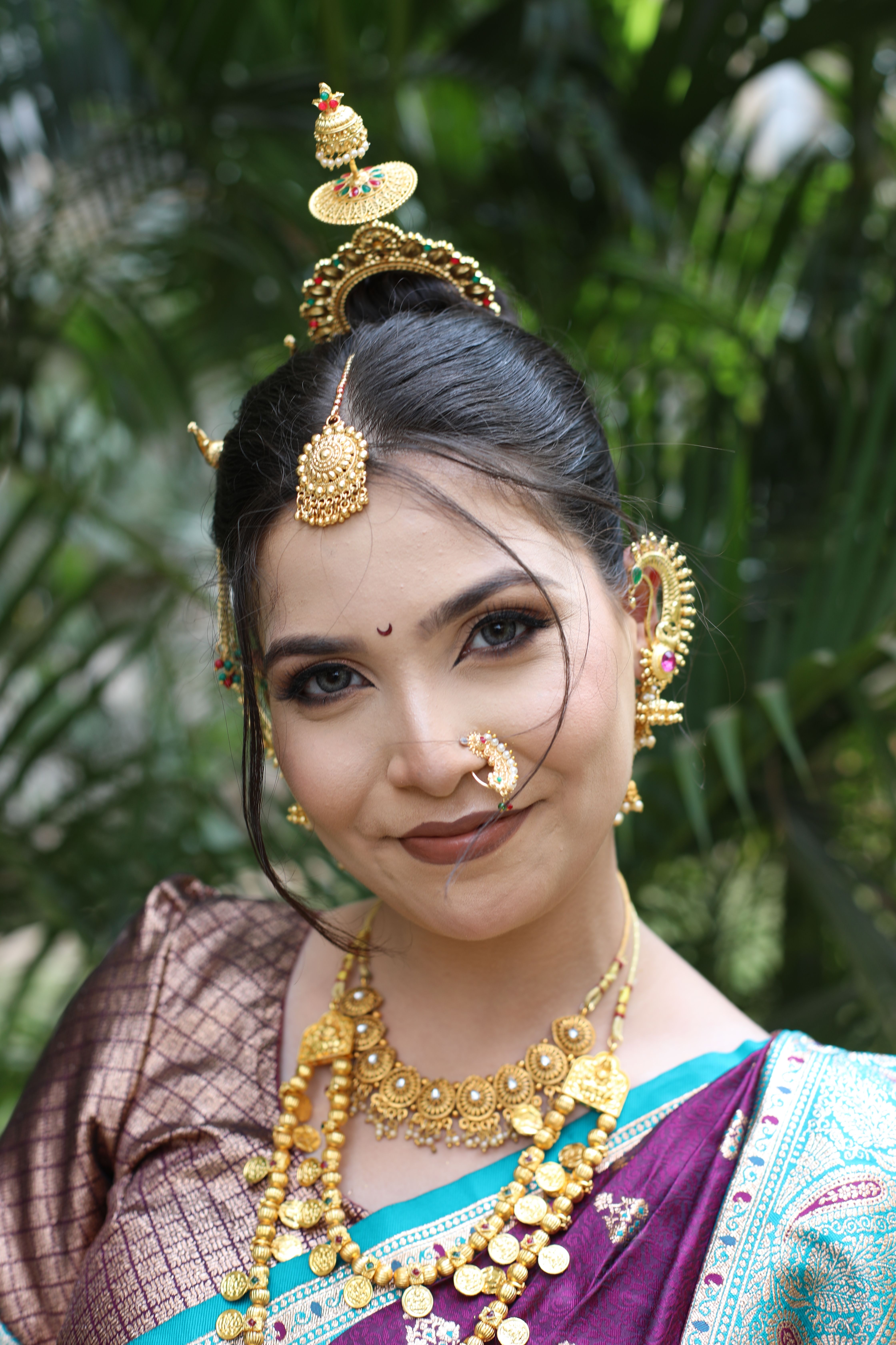 Beautiful woman in traditional attire with intricate jewelry and headpiece.
