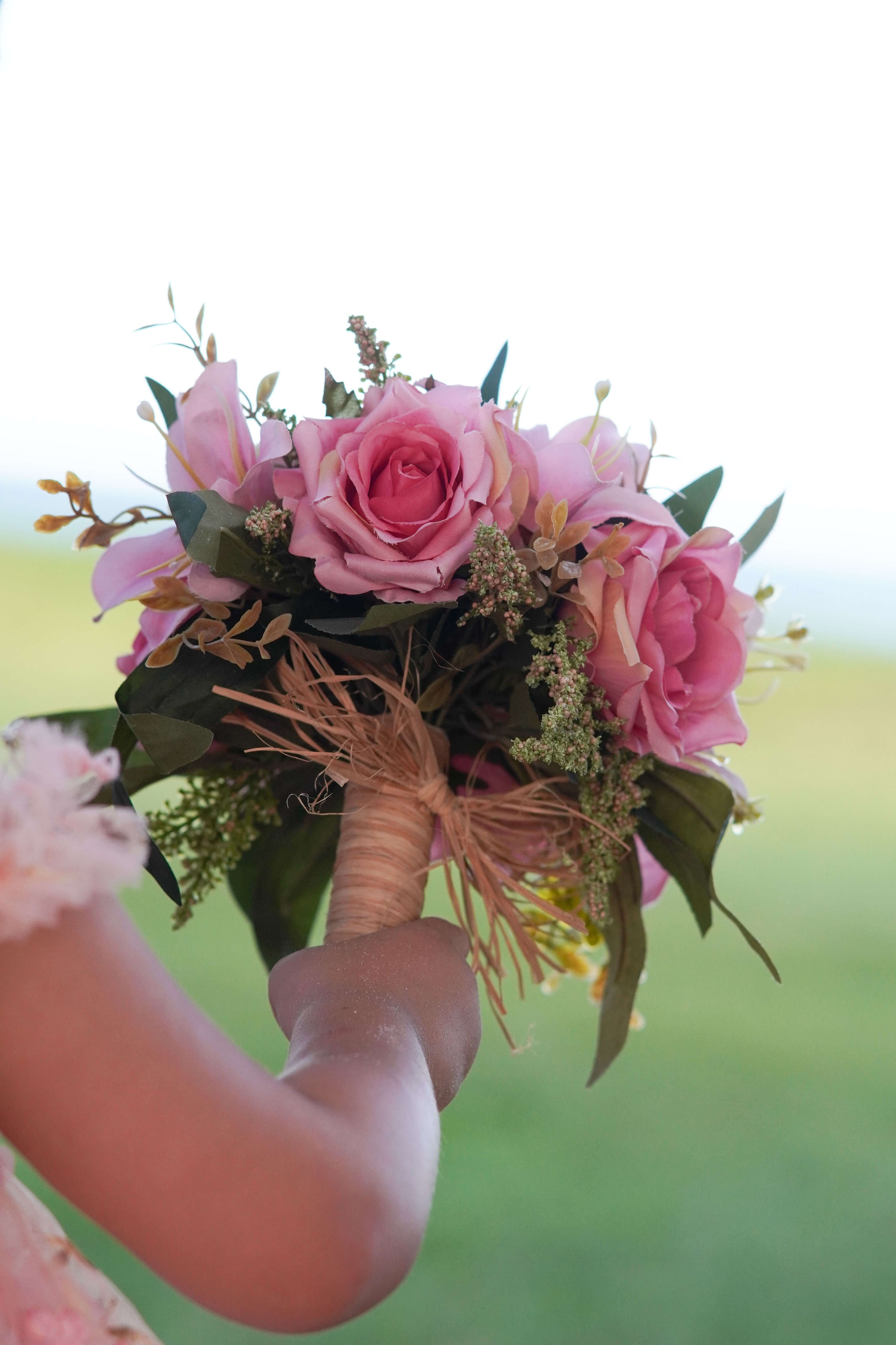 Child Holding Pink Rose Bouquet Outdoors · Free Stock Photo