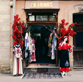 Ethnic fashion shop entrance in Lviv, showcasing colorful traditional costumes and decor.