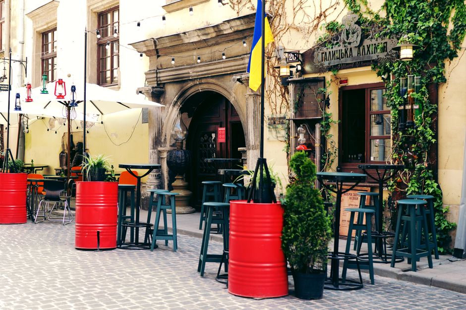 People enjoying an outdoor cafe in Bucharest during a warm Romanian summer day