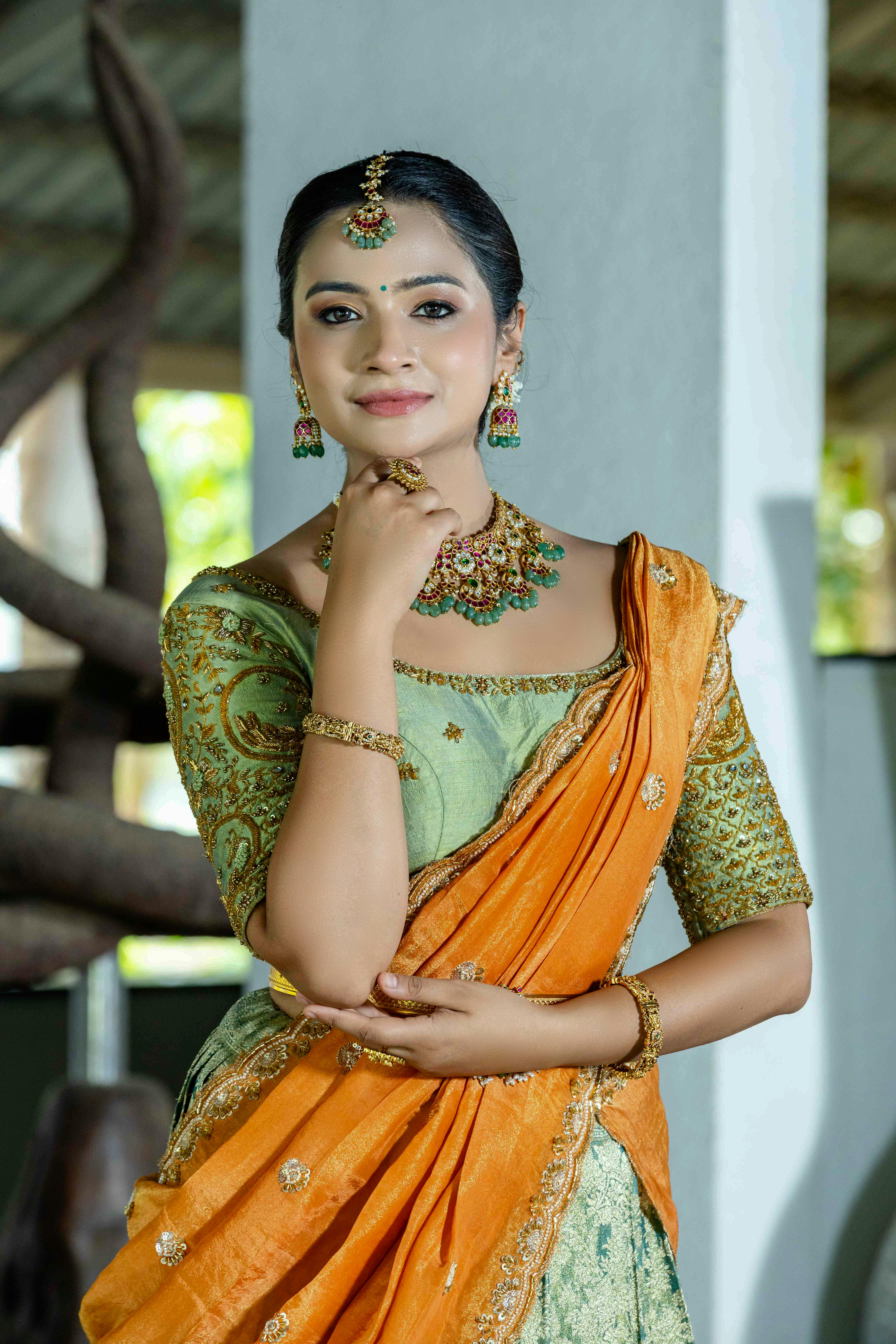 Portrait of a woman in traditional Indian saree with intricate jewelry, exuding elegance and cultural richness.