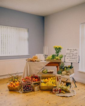 Colorful arrangement of various fruits and vegetables indoors, ideal for healthy lifestyle themes.