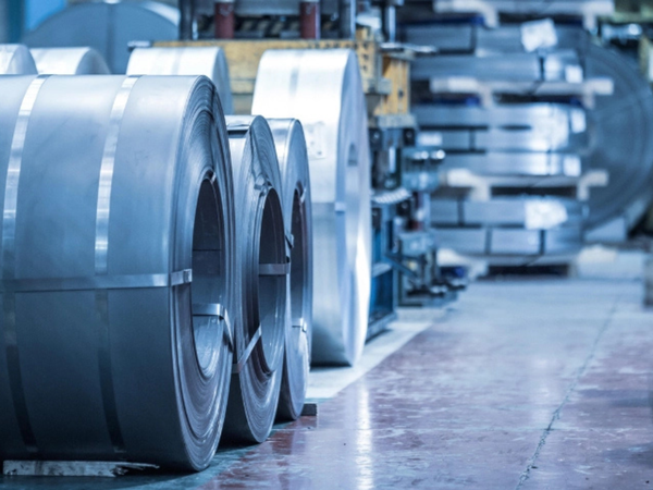 Close up view of coiled metal sheets showing a clean, consistent surface finish