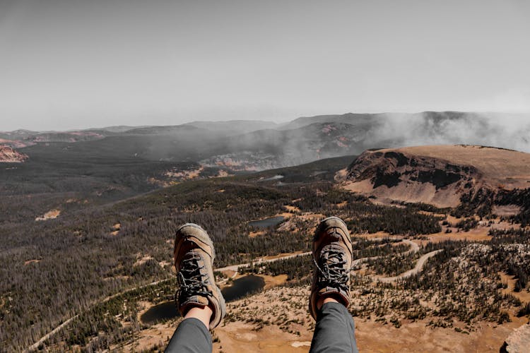 Crop Hiker Relaxing On Mountain After Achieving Peak