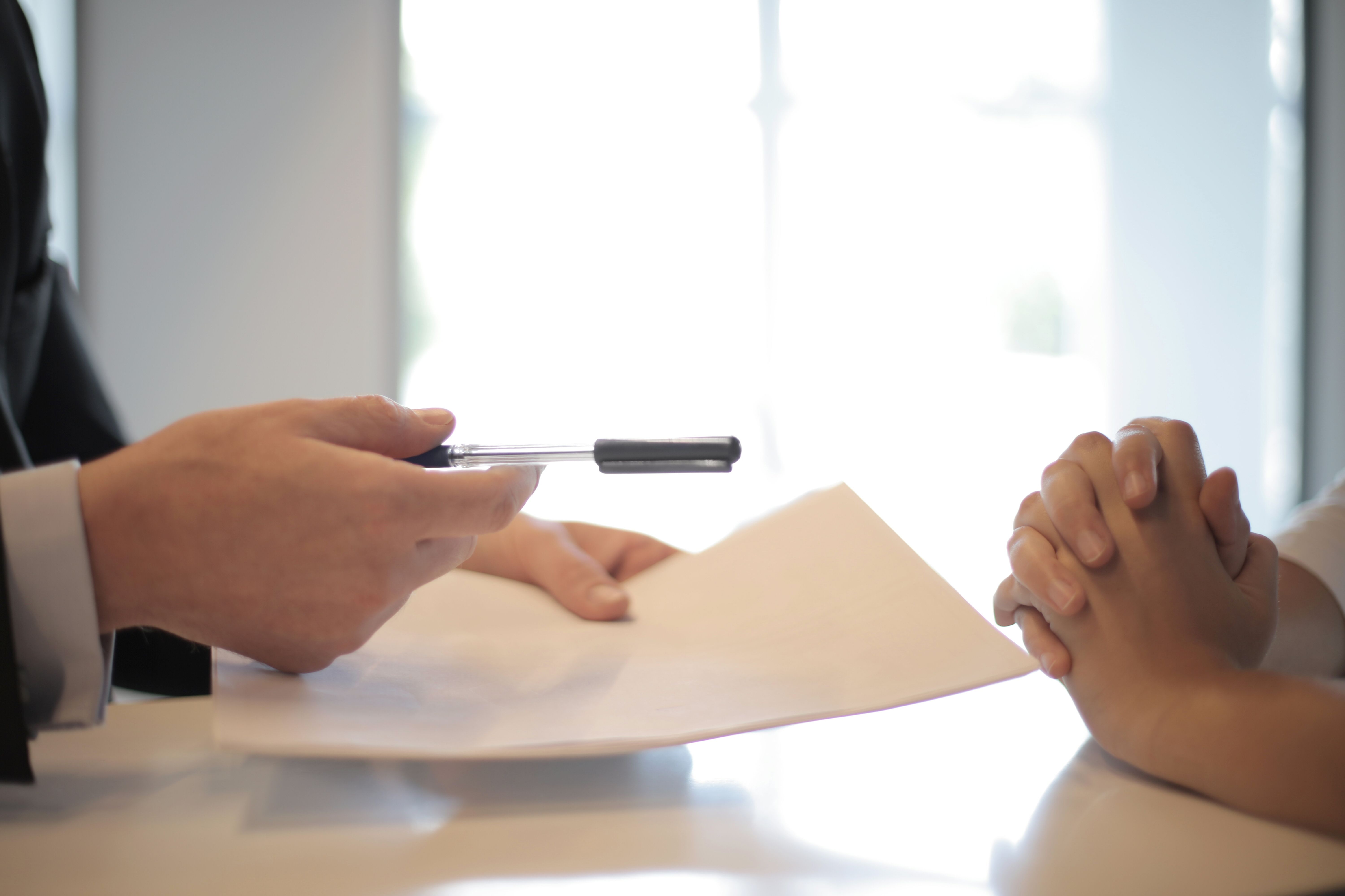 A person giving another a document