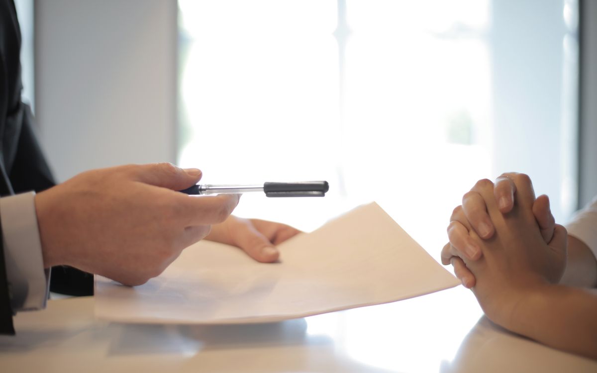 Person reviewing an insurance policy document at a desk