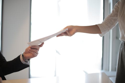 Free Job Applicant Passing Her Documents Stock Photo