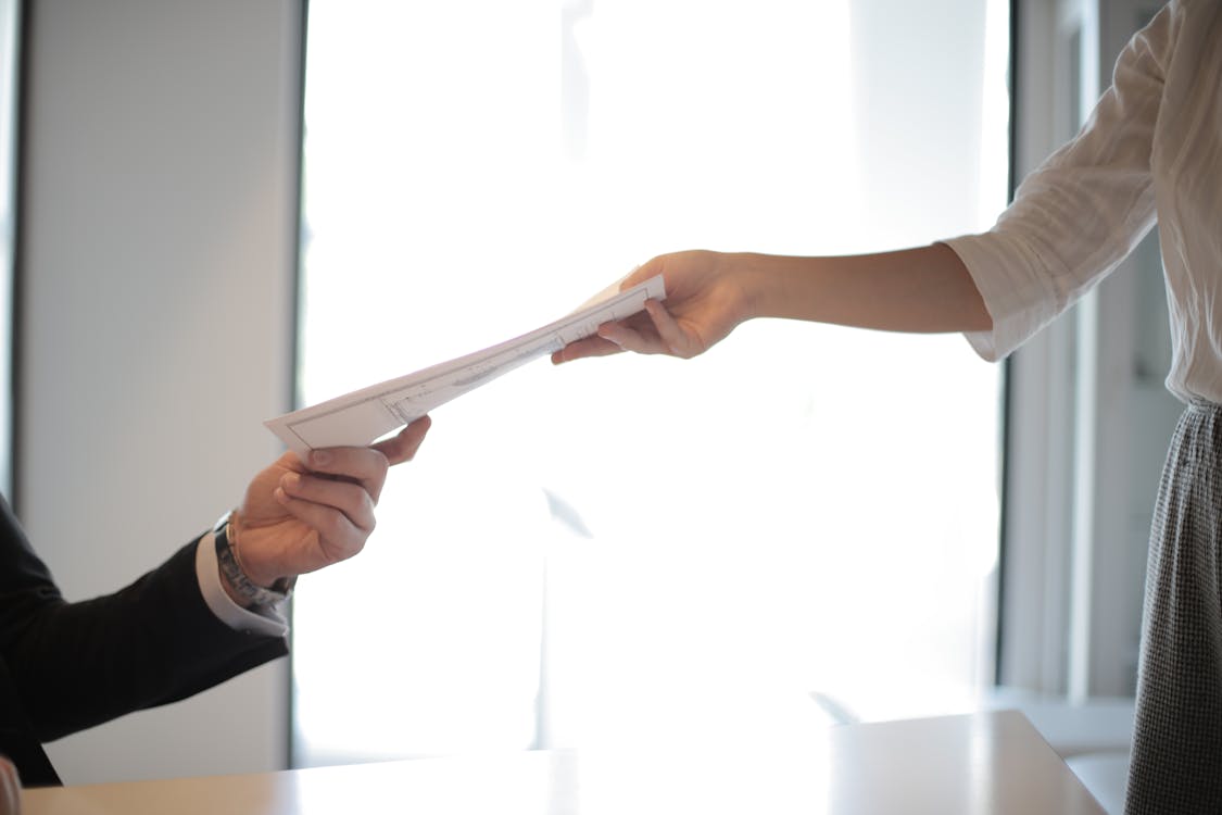 Free Job Applicant Passing Her Documents Stock Photo