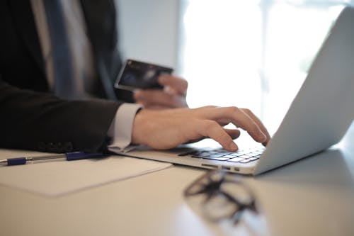 Free Person in Black Suit Typing on a Computer Stock Photo