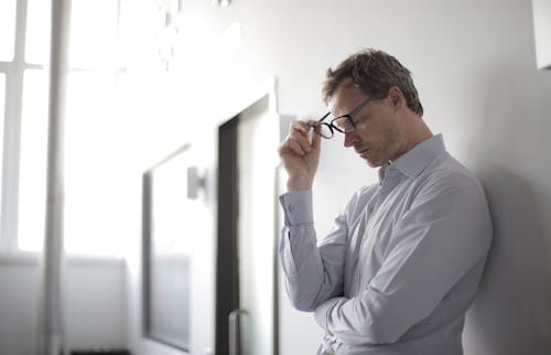 Free Photo Of Man Holding Black Eyeglasses Stock Photo