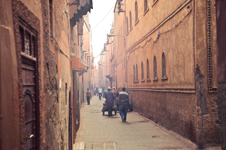 Pedestrians On Narrow Street Of Ancient City