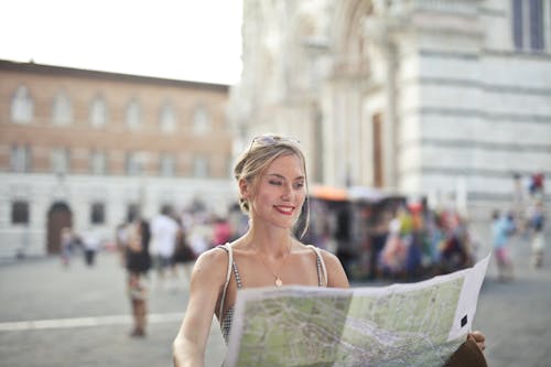 Free Woman Holding A Map Looking For Next Destination Stock Photo