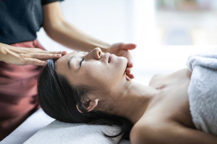 Selective Focus Photo Of Woman Getting A Head Massage