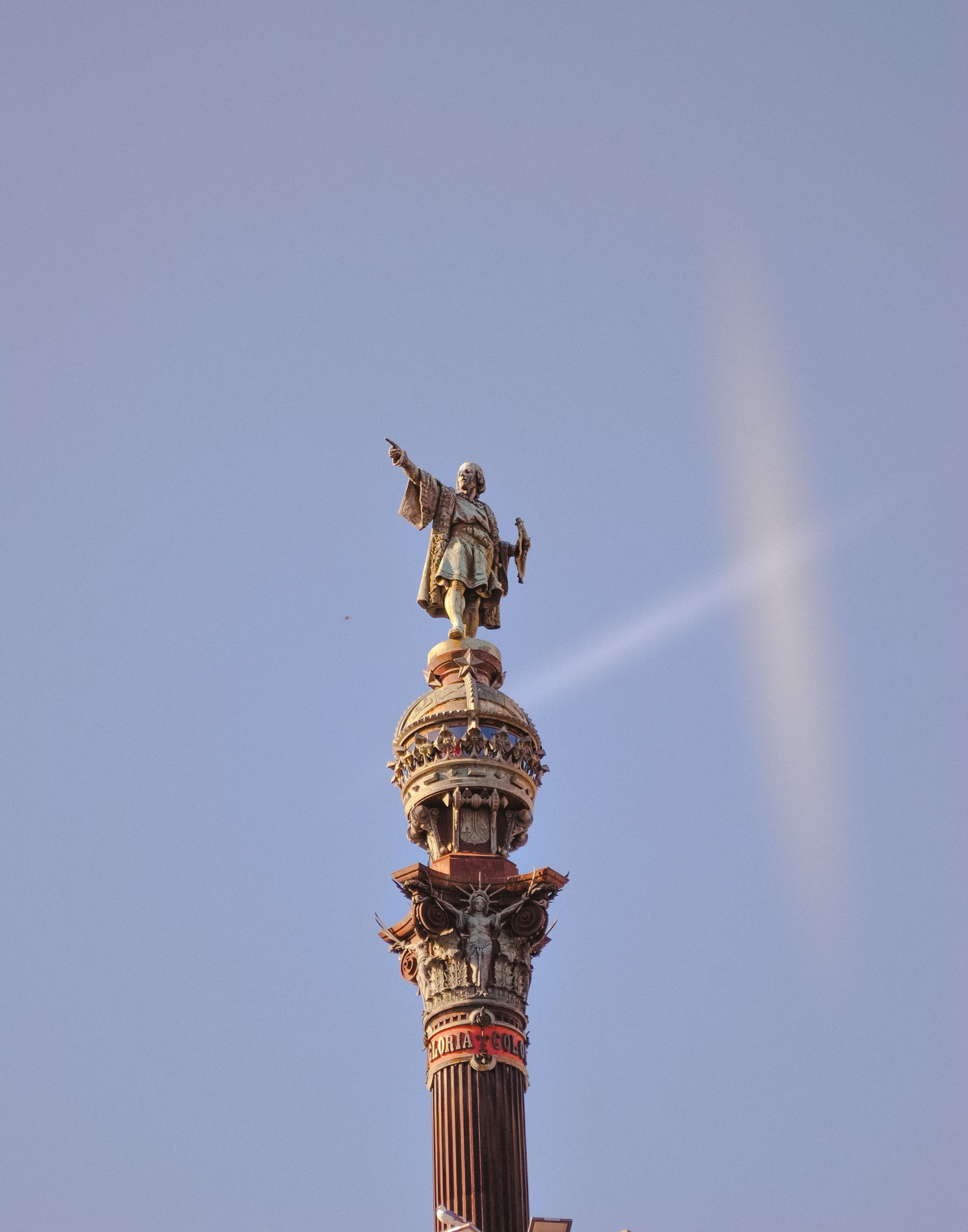 The iconic Columbus Monument in Barcelona against a clear sky.