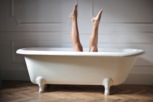 Photo of Female Legs in Bathtub