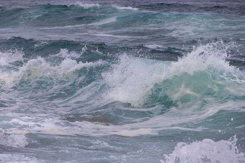 Free Vibrant ocean waves crashing dynamically, displaying natural beauty and power. Stock Photo