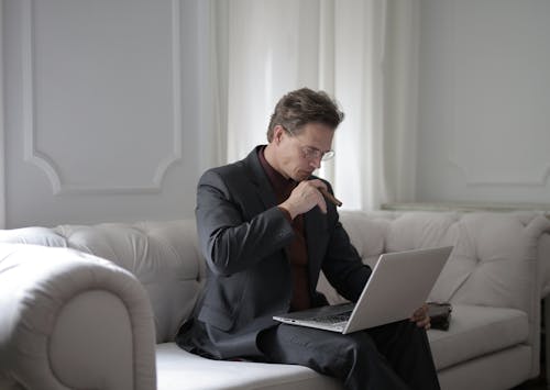 Man In Black Suit Holding a Cigarette