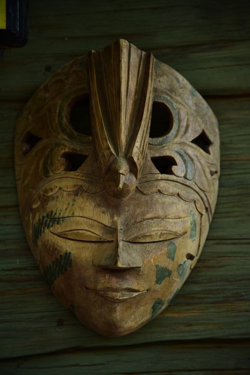 Free Close-up of a handcrafted tribal mask made from wood featuring detailed carvings and patterns. Stock Photo