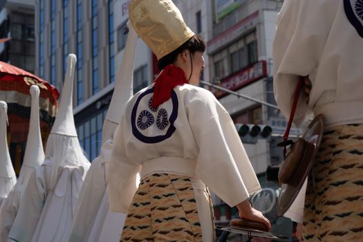 Traditional attire at a vibrant street festival in Tokyo, Japan.