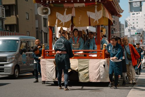 Free A vibrant street parade featuring traditional Japanese outfits and a float in Tokyo. Stock Photo