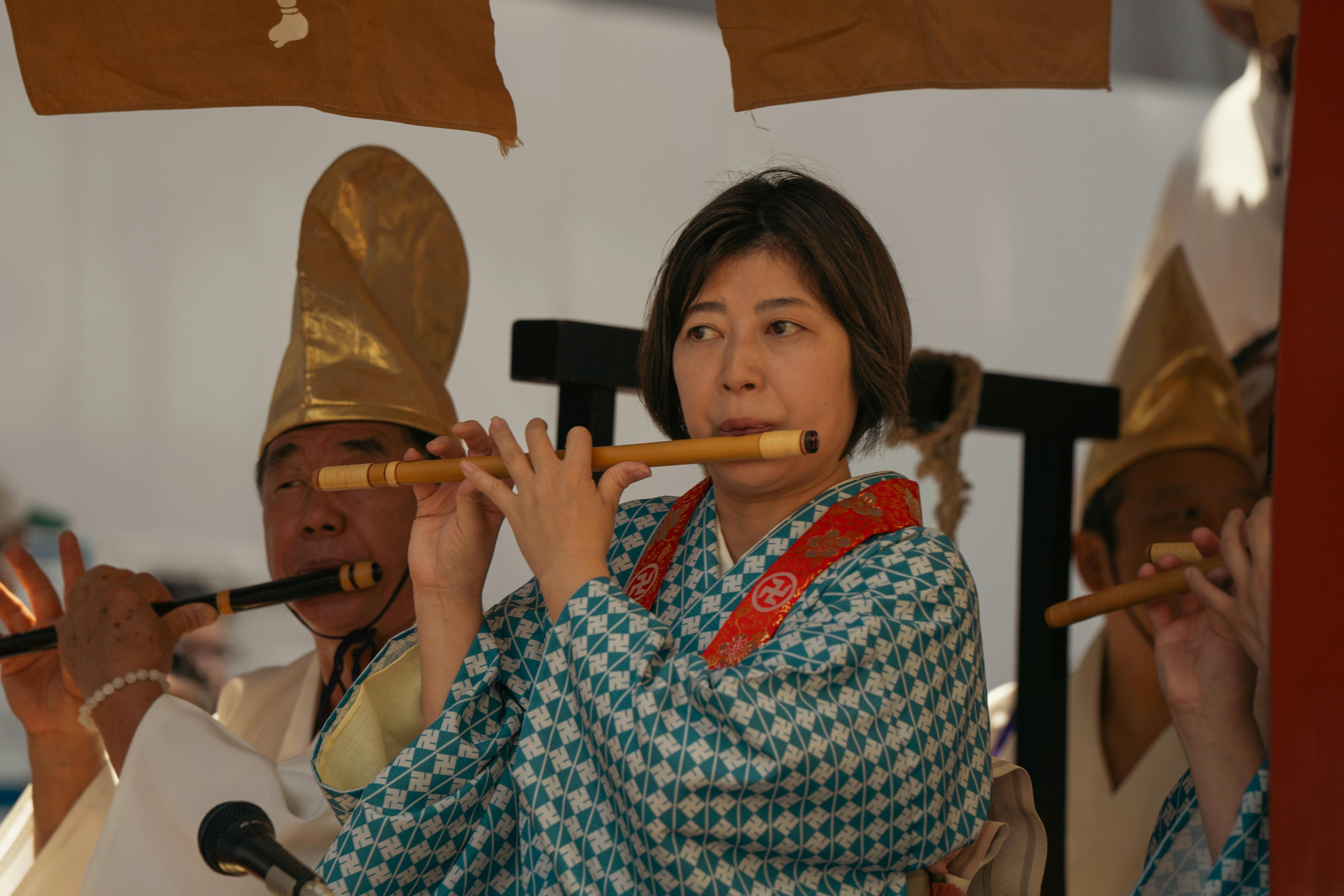 Cultural music performance with traditional attire and flute in Tokyo, Japan.