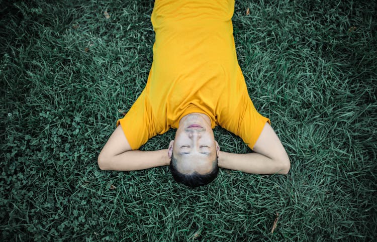 Photo Of Person Laying On Grass Field