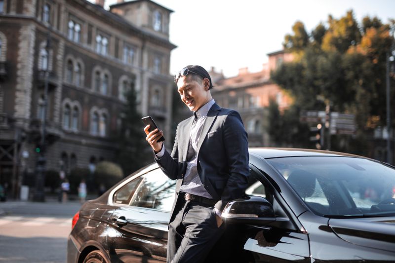 Person checking a phone in a parked car