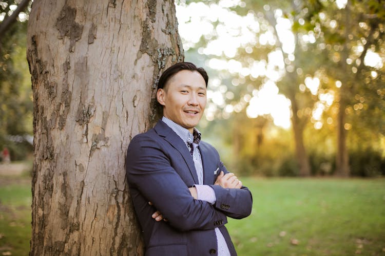 Photo Of Man Leaning On Tree