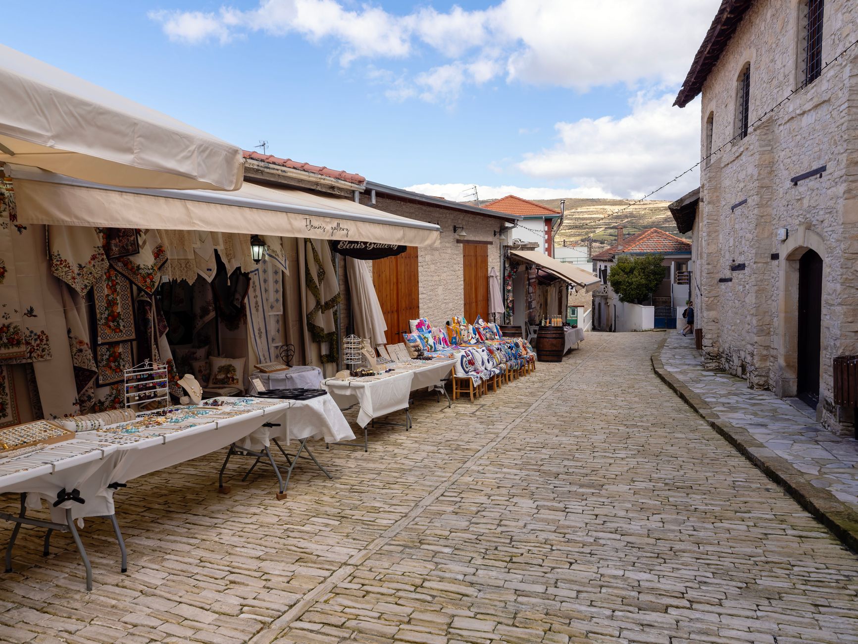Narrow stone lane with lace shops and shuttered houses in Pano Lefkara