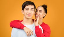 Woman Whispering in Mans Ear