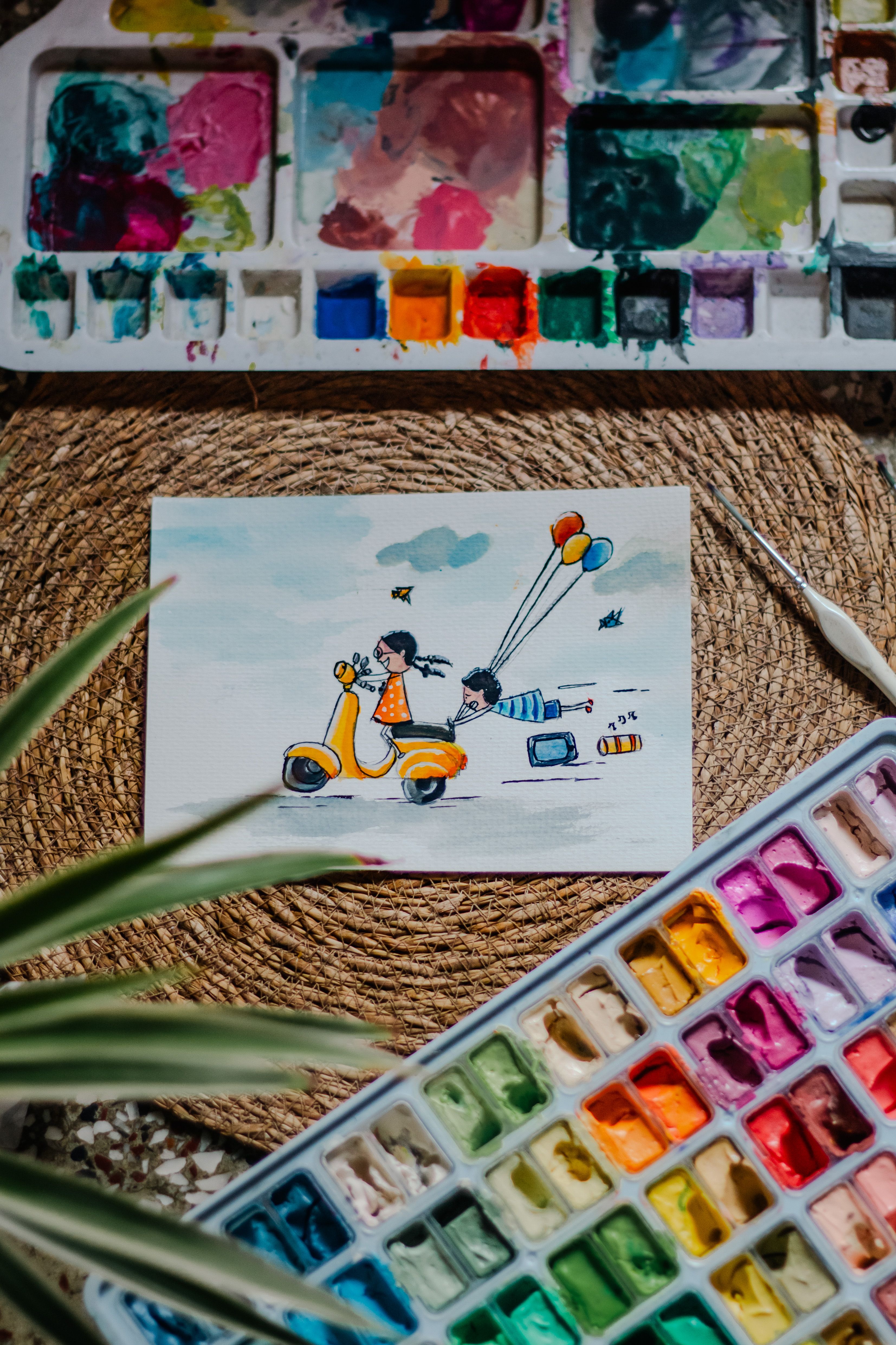 Vibrant watercolor illustration of a Vespa scooter with painting tools. Creative and artistic setup.