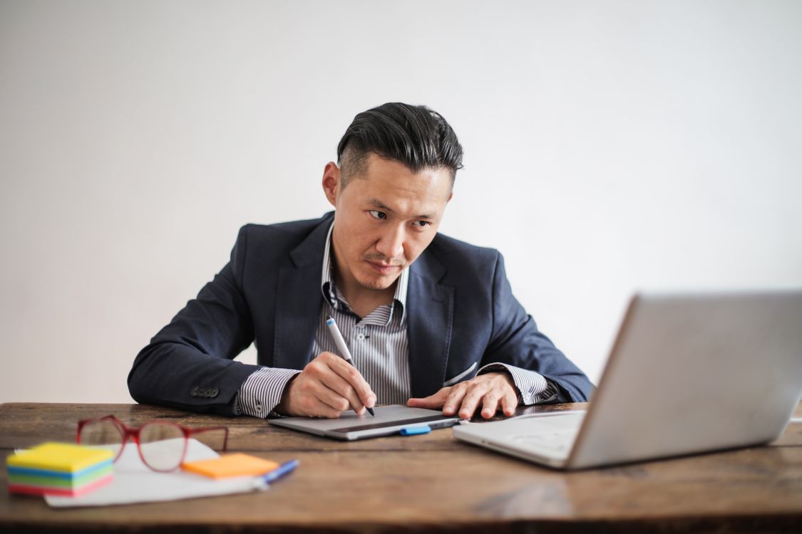 Man in Black Suit Jacket Using Macbook Pro · Free Stock Photo