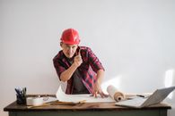 Man in Red and Black Shirt Wearing Red Hard Hat