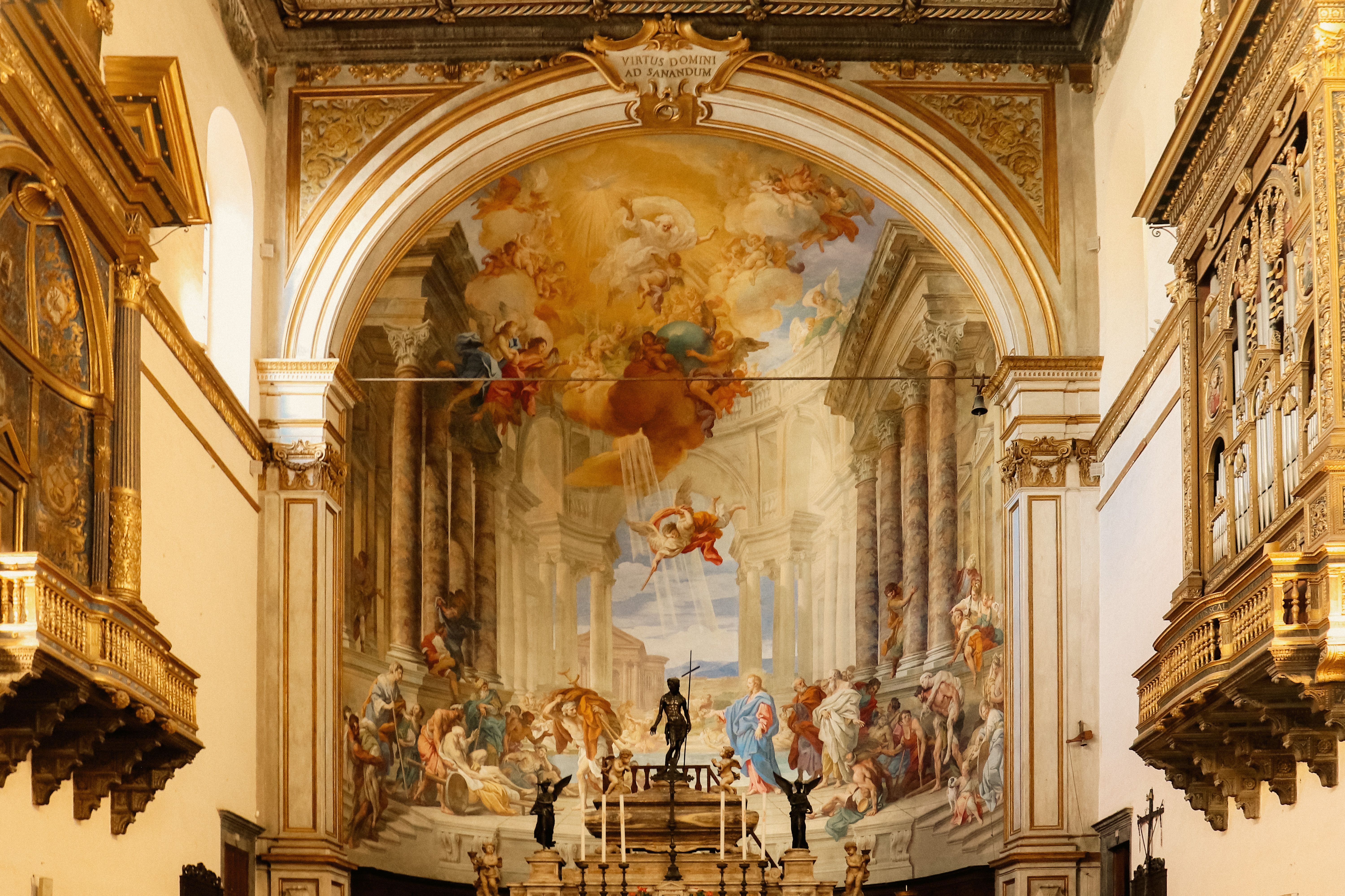 Detailed fresco painting inside a historical Tuscan church showcasing classical architecture.