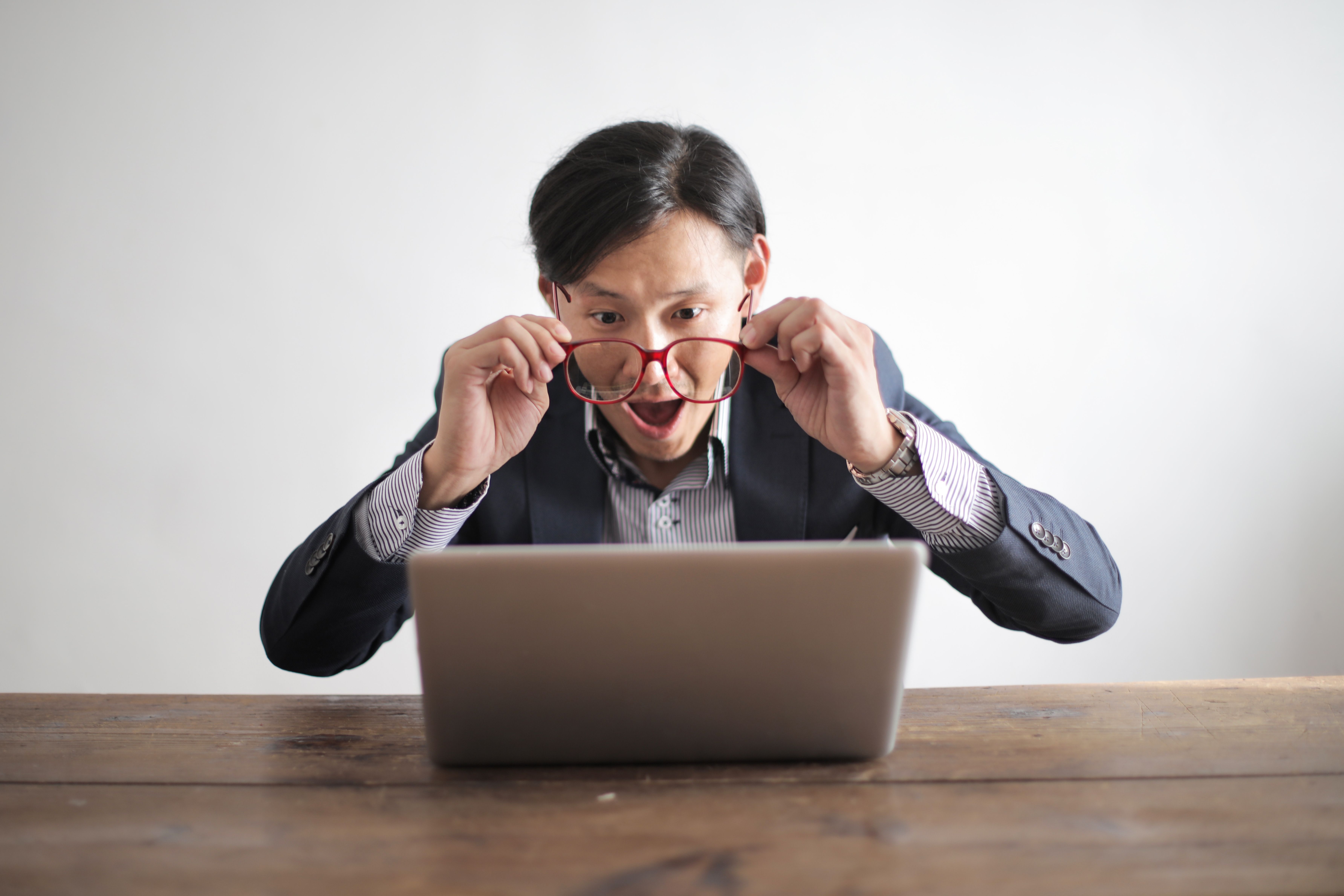 Man shocked looking at his laptop