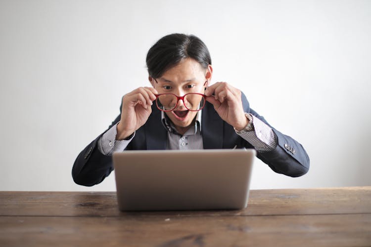 Amazed Formal Male Looking At Laptop Screen