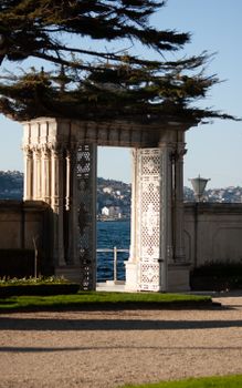 Elegant ornate gate framing a view of the Bosphorus waterway, in İstanbul, Türkiye.