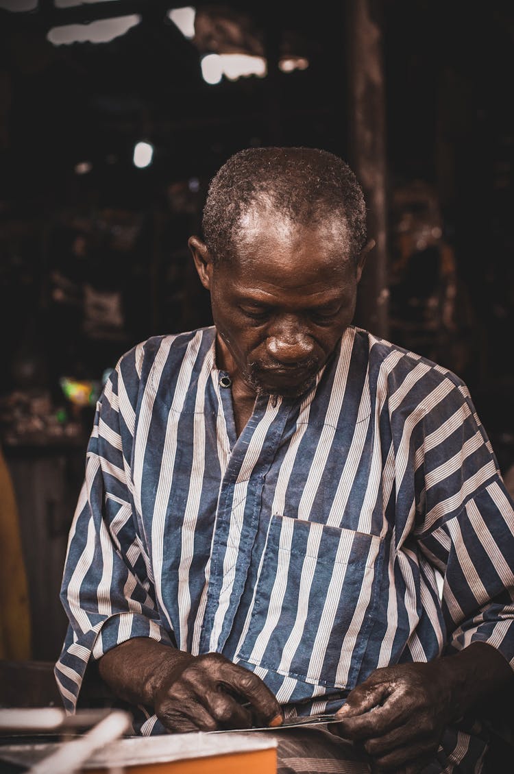 African Man Cutting Board In Workshop