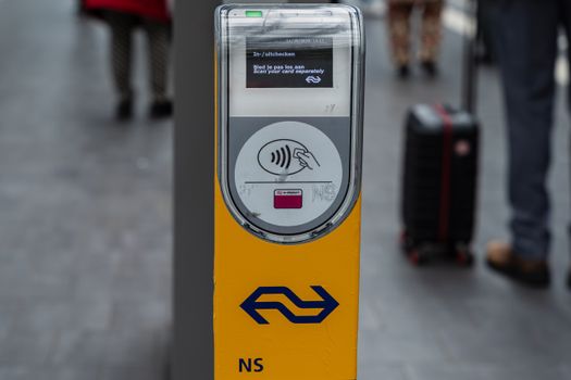 Close-up of NS contactless card reader at a station. Ideal for travel themes.