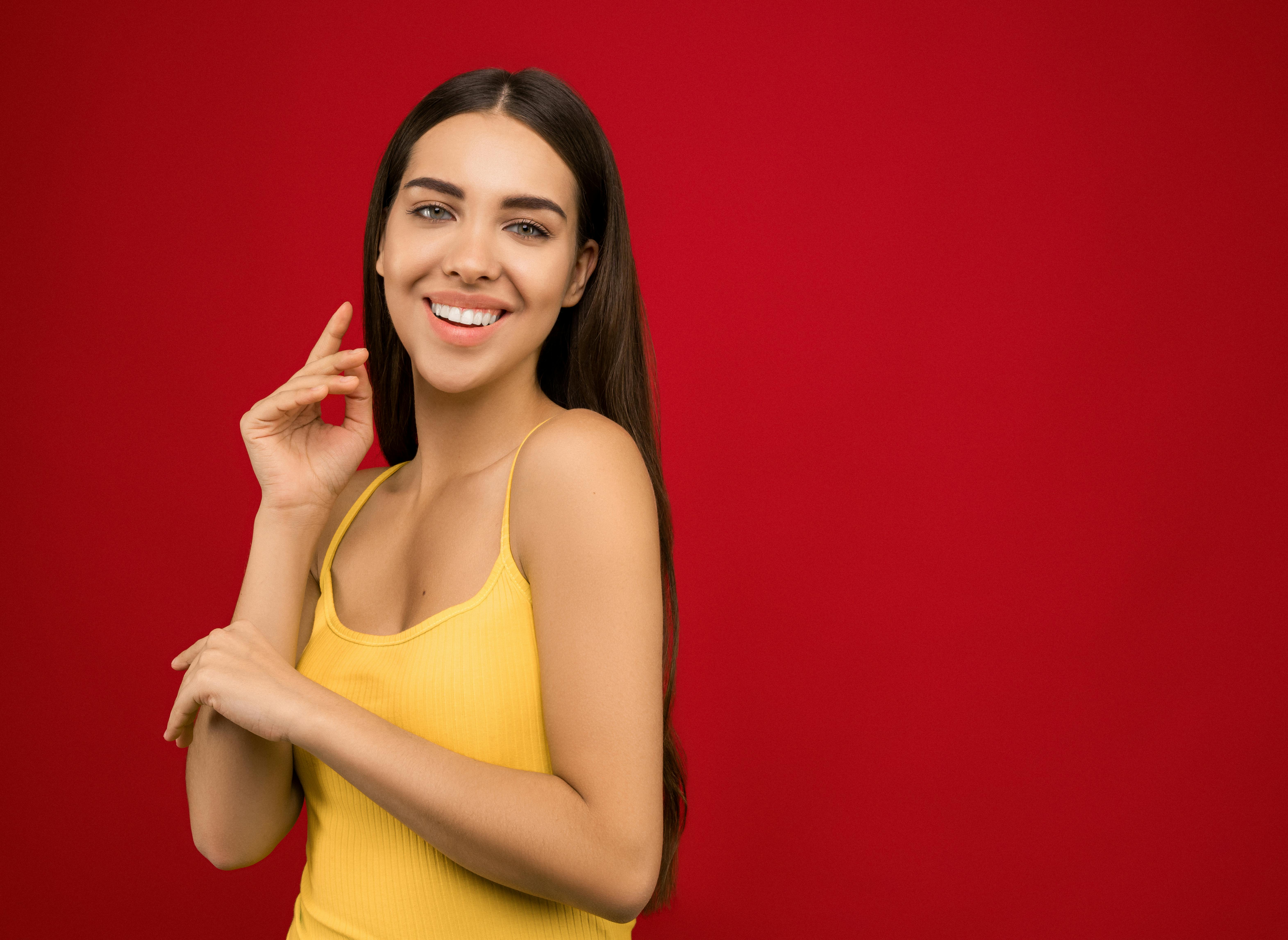 woman in yellow tank top smiling