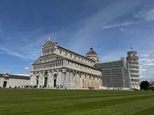 Free The Leaning Tower of Pisa and Cathedral under a bright blue sky in Tuscany, Italy. Stock Photo